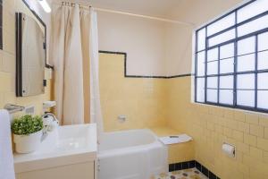 a bathroom with a white tub and a sink at Casa 906 in Puebla +70 photos