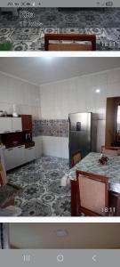 Una cocina con un refrigerador y una mesa dentro. en Cantinho do aconchego, en Guarujá