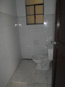 a bathroom with a toilet and a window at Gran Hotel El Cedro in Girardot