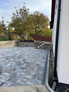 a patio outside of a house with a bench at Apartmán Veronika in Humpolec