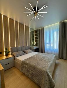 Ένα ή περισσότερα κρεβάτια σε δωμάτιο στο Apartment Modern Chișinău