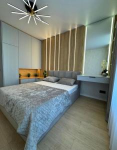 Ένα ή περισσότερα κρεβάτια σε δωμάτιο στο Apartment Modern Chișinău