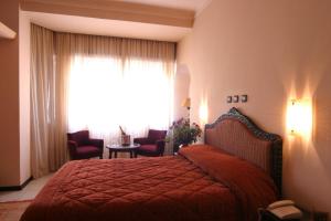 A bed or beds in a room at Hotel Chellah