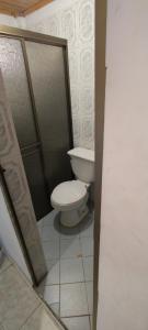 a bathroom with a white toilet in a stall at CASA EN EL BARRIO CÁNDIDO CERCA AL CC ÚNICO y AL AEROPUERTO in Neiva +10 photos