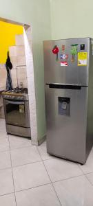 a refrigerator and a stove in a kitchen at CASA EN EL BARRIO CÁNDIDO CERCA AL CC ÚNICO y AL AEROPUERTO in Neiva