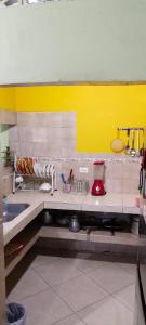 a kitchen with a counter with dishes on it at CASA EN EL BARRIO CÁNDIDO CERCA AL CC ÚNICO y AL AEROPUERTO in Neiva +9 photos