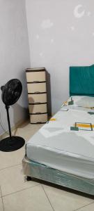 a bedroom with a bed and a chair next to it at CASA EN EL BARRIO CÁNDIDO CERCA AL CC ÚNICO y AL AEROPUERTO in Neiva