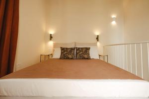 a bedroom with a large bed with two pillows at Traditional Maltese home in the three cities in Cospicua +12 photos