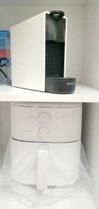 a microwave sitting on top of a white shelf at Jasmine Home, Aegina City in Egina +22 photos