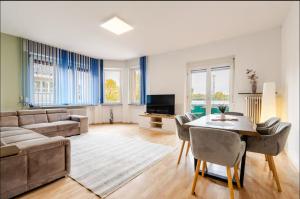 a living room with a couch and a table at Worms City Apartment in Worms
