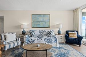 a living room with a couch and a table at Modern Gulf Front Condo, Pool, 2 Hot Tubs, Platinum Beach Service, Endless Views in Navarre +51 photos