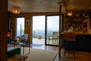 a living room with a large sliding glass door at Sky Garden Cabin - Cabin in the Clouds in Charlton Kings