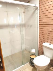 a bathroom with a toilet and a glass shower at Cabana liberdade 2 in Rio dos Cedros +41 photos