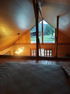a bedroom with a bed and a large window at Cabana liberdade 2 in Rio dos Cedros