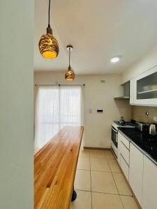 a kitchen with a wooden counter top in a room at Departamento Las Marias in Olavarría