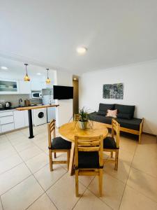 a living room with a table and chairs and a couch at Departamento Las Marias in Olavarría