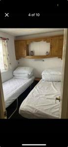 two twin beds in a small room with at CSS butlins Skegness retreat in Skegness
