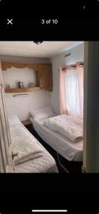 a room with two beds and a window at CSS butlins Skegness retreat in Skegness