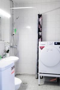a bathroom with a sink and a shower and a toilet at Railway&bus station studio, parking in Oulu