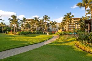 a view of a resort with palm trees and a pathway at Honua Kai Konea 206 in Lahaina