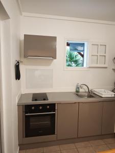 a kitchen with a sink and a stove at Enjoy Studio in Pointe-Noire