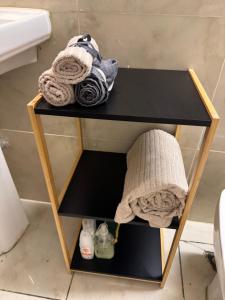 a small black table with towels on it in a bathroom at L'herbe à pic. in Les Abymes +34 photos