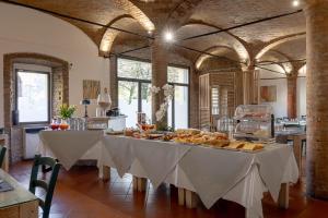 a large room with a table with food on it at Villa D&D in Parma