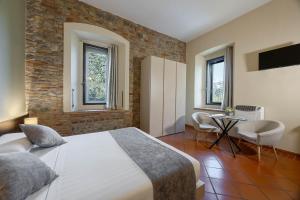 a bedroom with a bed and a table and chairs at Villa D&D in Parma