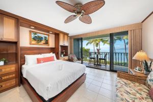 a bedroom with a bed and a balcony at Lahaina Shores 229 in Lahaina +45 photos