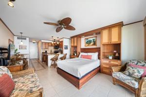 a bedroom with a bed and a living room at Lahaina Shores 229 in Lahaina