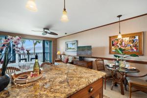 a kitchen and living room with a table and chairs at Lahaina Shores 229 in Lahaina