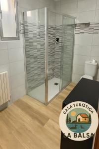 a bathroom with a shower with a sign that says eastern transmitter a ballasis at La Balsa in Matalebreras