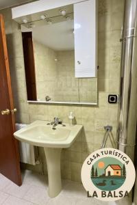 a bathroom with a sink and a mirror at La Balsa in Matalebreras