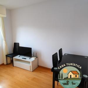 a room with two chairs and a desk and a table at La Balsa in Matalebreras