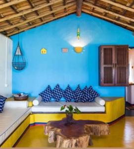 uma parede azul com um sofá num quarto em Casa Mar em Porto Seguro mais 9 fotografias
