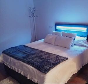 a bedroom with a large bed with white sheets and pillows at O Caminho Azul in Olivenza +50 photos
