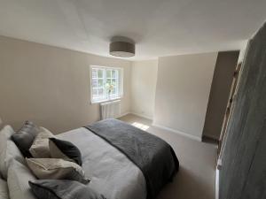 a bedroom with a large bed with a window at The Old Forge in Wendover