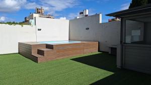 a backyard with a swimming pool on the side of a house at LoftPoint Rosario, Pileta, Solarium y Terraza con vista al Río in Rosario +16 photos