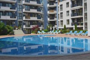 a large swimming pool in front of a building at Amphora Palace Apartment Complex in Golden Sands +17 photos