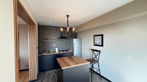 een keuken met een houten aanrecht en een koelkast bij Sea view luxury in Baku