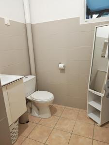 a bathroom with a toilet and a sink at Enjoy Studio in Pointe-Noire +34 photos