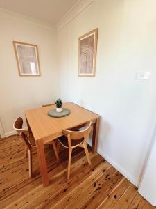 a wooden table and chairs in a room at Prickly Pear Stays in Merewether - Ranclaud St in Merewether +10 photos