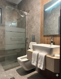 a bathroom with a sink and a toilet and a shower at 3BR 5Bed luxury apartment in Jeddah