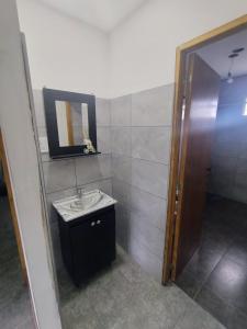 a bathroom with a sink and a mirror at Apart Cuyo in San Rafael