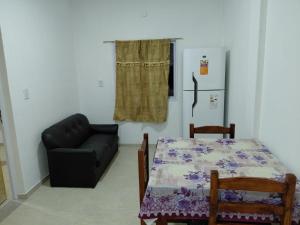 a living room with a table and a couch at Alojamiento Marcenal in Empedrado
