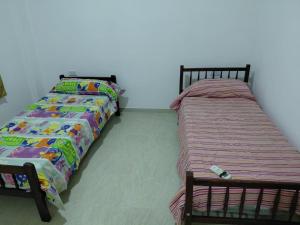 two beds sitting next to each other in a room at Alojamiento Marcenal in Empedrado