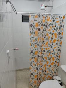 a bathroom with a shower curtain with a toilet at Alojamiento Marcenal in Empedrado