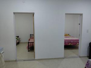 two mirrors in a room with a bed at Alojamiento Marcenal in Empedrado