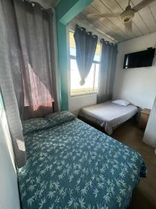 Postel nebo postele na pokoji v ubytování Hotel Rio Puntarenas