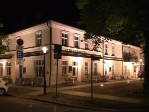 a white building with a sign in front of it at Schlosshotel Rheinsberg in Rheinsberg +25 photos